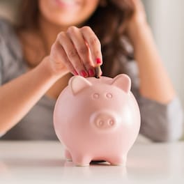 Coin being put in piggy bank